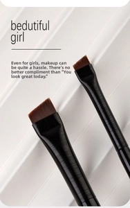 Macro detail of professional flat angled eyeliner and eyebrow brushes with fiber bristles