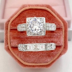Macro shot of a silver cubic zirconia bridal ring set in a pink velvet jewelry box