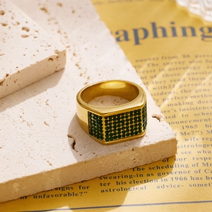 Close-up of gold plated square signet ring with micro-paved green zircon gemstones