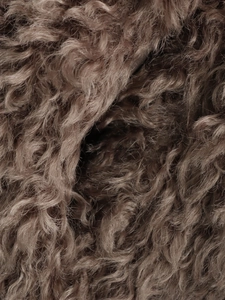 Close-up of the thick brown curly faux fur texture on this fashionable warm coat