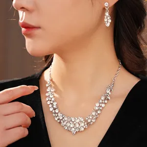Elegant geometric rhinestone jewelry set featuring a necklace and stud earrings on a model