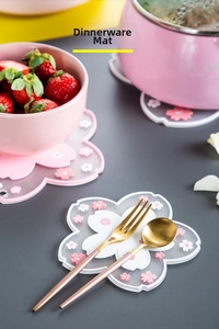 Detailed view of pink cherry blossom heat-resistant silicone placemats in a kitchen setting