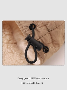 Close-up of diamond quilted fabric with warm sherpa lining and adjustable toggle drawcord