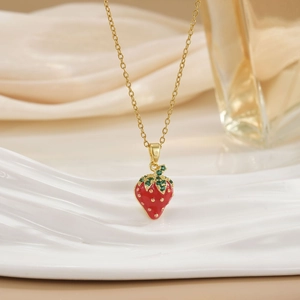 Luxurious gold chain necklace featuring a realistic red cherry pendant with green crystals