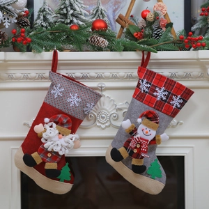 Set of large Christmas stockings with 3D Santa and Snowman hanging on white fireplace