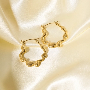 Chic 18K gold plated irregular wavy earrings displayed on elegant silk fabric