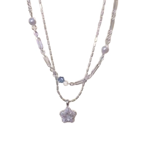 Double-layered necklace with zircon star pendant and pearl beads on a fine silver chain