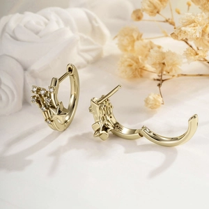Vintage gold meteor earrings with micro-set zircon stones on elegant white fabric