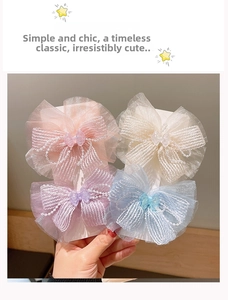 Detail view of four-piece layered chiffon bow hair clips with faux pearl bead edges