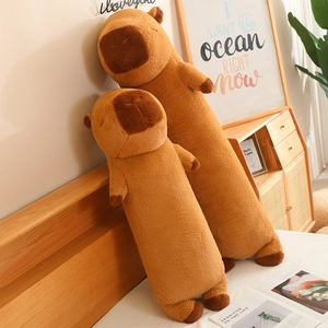 Detailed view of two plush capybara body pillows in a cozy bedroom setting