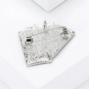 Detailed back view of silver poker card brooch showing metal texture and safety pin clasp