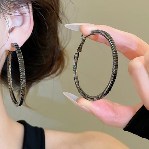 Detail of large gunmetal hoop earrings with micro-pave black cubic zirconia stones