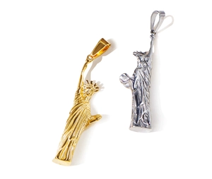 Detailed view of Lady Liberty pendants in gold and silver finish stainless steel