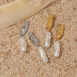 Stainless steel baroque pearl earrings with hammered metal texture on sand background