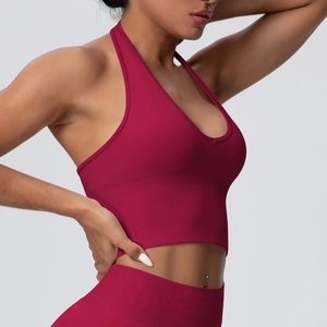 Macro view of burgundy seamless ribbed knit fabric on a high-impact halter sports bra
