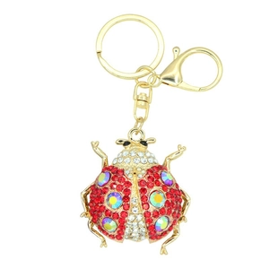 Close-up of ladybug keychain with red rhinestones and laser crystals on gold alloy