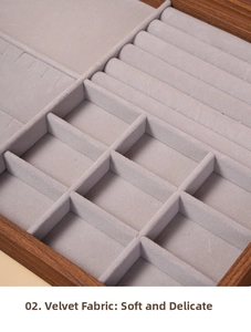 Detail view of walnut wood jewelry box with gray velvet lining and ring storage slots
