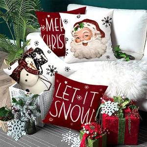 Christmas Santa Claus cushion covers in red and white on a cozy white sofa setting