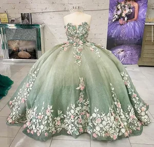 Detail of sage green ball gown featuring 3D floral appliques and shimmering glitter tulle
