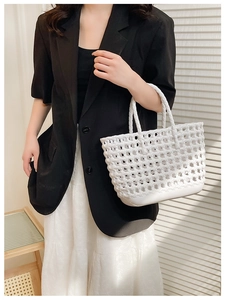 Detail of white hollow woven jelly basket bag showing material texture and open structure