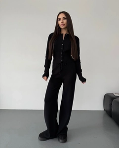 Relaxed black knit set with a button-up long sleeve cardigan and wide-leg trousers