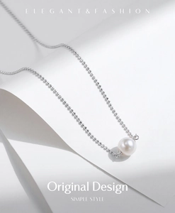 Detailed view of an s925 silver chain with a single white round pearl pendant