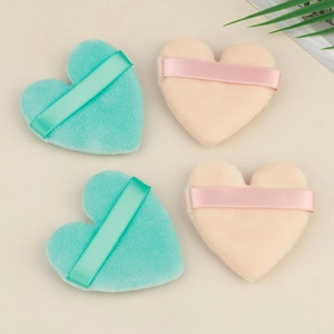 Set of four heart-shaped velvet makeup puffs in green and pink with satin ribbons