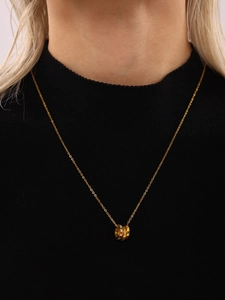 Detail of three-ring interlocking necklace with colorful crystals on a black neckline