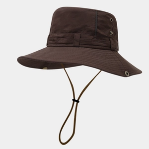 Detail of dark brown outdoor sun hat featuring breathable metal eyelets and adjustable chin cord