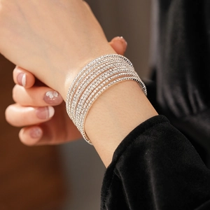 Close-up of a multi-layer silver crystal bracelet with sparkling rhinestones on wrist