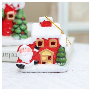 Detailed close-up of a ceramic Christmas house ornament with Santa and a green tree