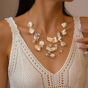 Detailed macro view of multilayer necklace with irregular shells and crystal beads