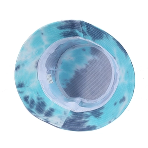 Detail of blue tie-dye bucket hat showing breathable mesh lining and cotton wash label