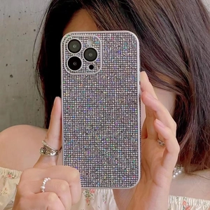 Sparkling diamond-encrusted iPhone cover with camera lens protection shown in hand