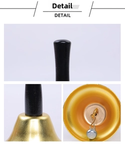 Detailed macro view of the gold handbell showing internal metal striker and handle joint