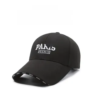 Detail of PARIS FRENCH embroidery and SPORT lettering on a black baseball cap
