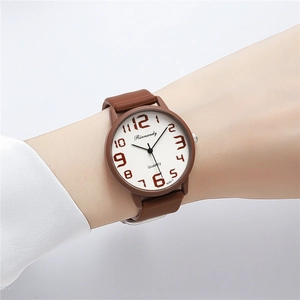 Close-up of Rinnandy quartz watch featuring brown silicone strap and clear numeric dial