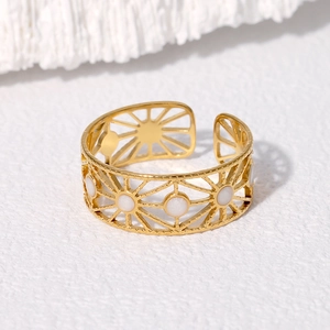 Adjustable gold stainless steel ring with geometric cutout sunburst and white enamel