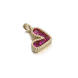 Detailed view of 14k gold heart pendant with magenta gemstones and beadwork