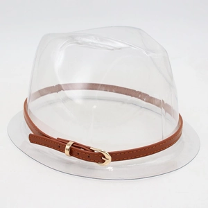 Detail view of a transparent stylish hat with a brown leather decorative band and gold buckle