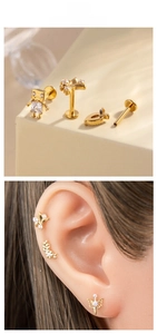 Detail view of gold titanium labret studs with zircon insets and flat back screw thread