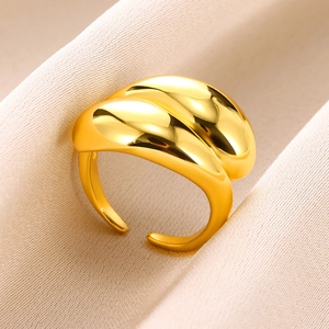 Macro detail of gold plated teardrop ring with mirror polished finish and open design