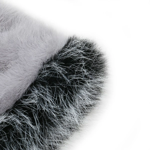 Macro shot of fluffy faux fur texture showing soft grey and frosted black fibers