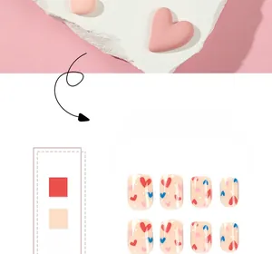 Detailed view of press-on nails featuring red and blue hearts on nude base with white dots