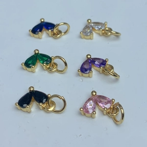 Detail showing multi-color pear-cut zircon heart pendants with golden metal base settings