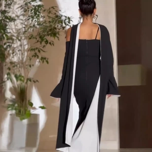 Elegant black and white floral off-shoulder dress with shawl design shown in back view