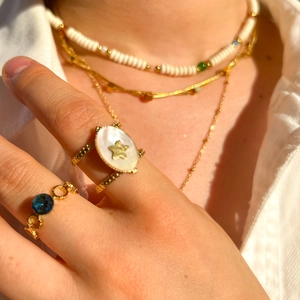 French retro gold necklace and rings set with blue gemstone and white beaded chain