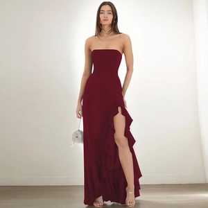 Close-up of strapless burgundy evening dress showing side slit and ruffle hem details