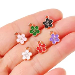Set of six colorful enamel five-petal flower pendants with gold-plated metal borders