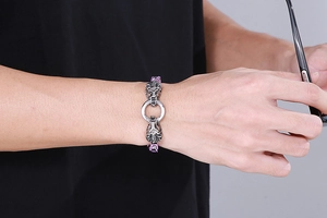 Close-up of a stainless steel men's king chain bracelet with detailed lion head clasp
